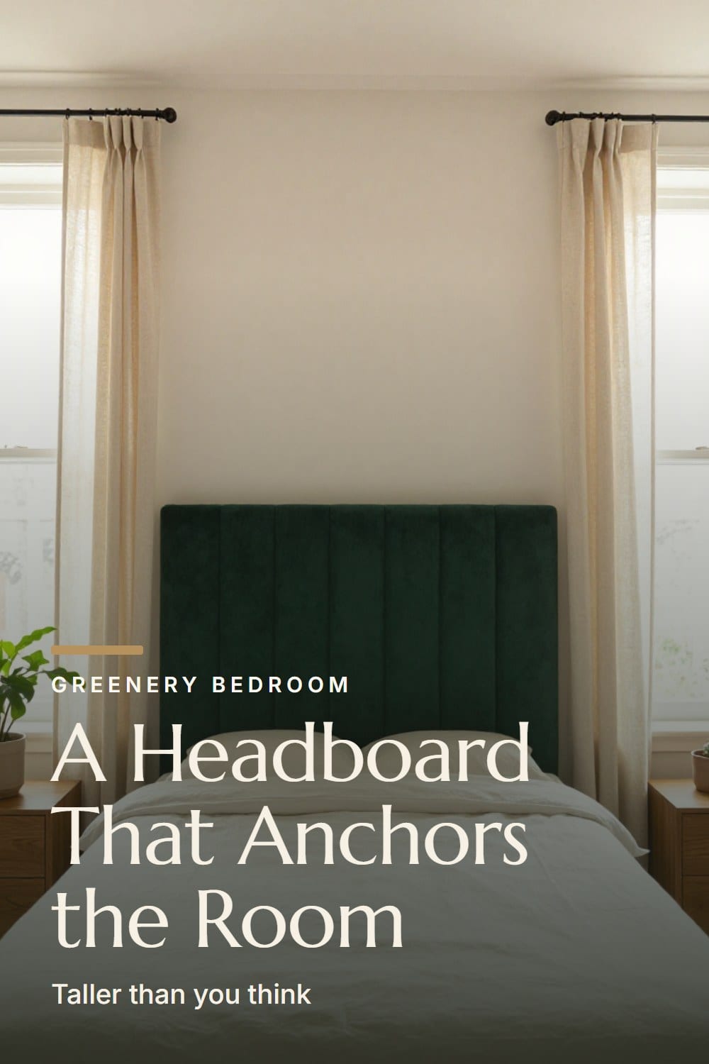 A tall emerald velvet headboard anchoring a bedroom wall between two windows with linen curtains