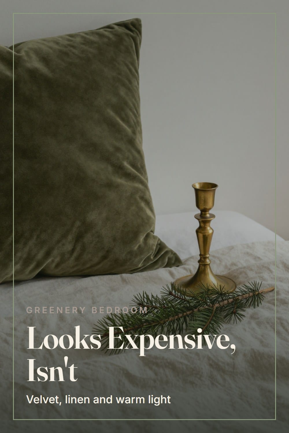 A Christmas bedroom that looks expensive with an aged brass candlestick, a heavy olive velvet pillow and a cedar sprig on a linen duvet