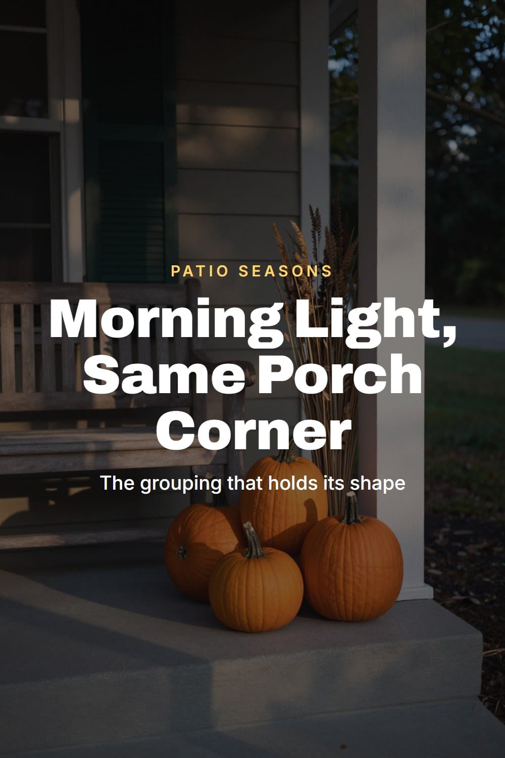 Fall porch corner in early morning light with staggered heirloom pumpkins and dried grasses on a teak bench