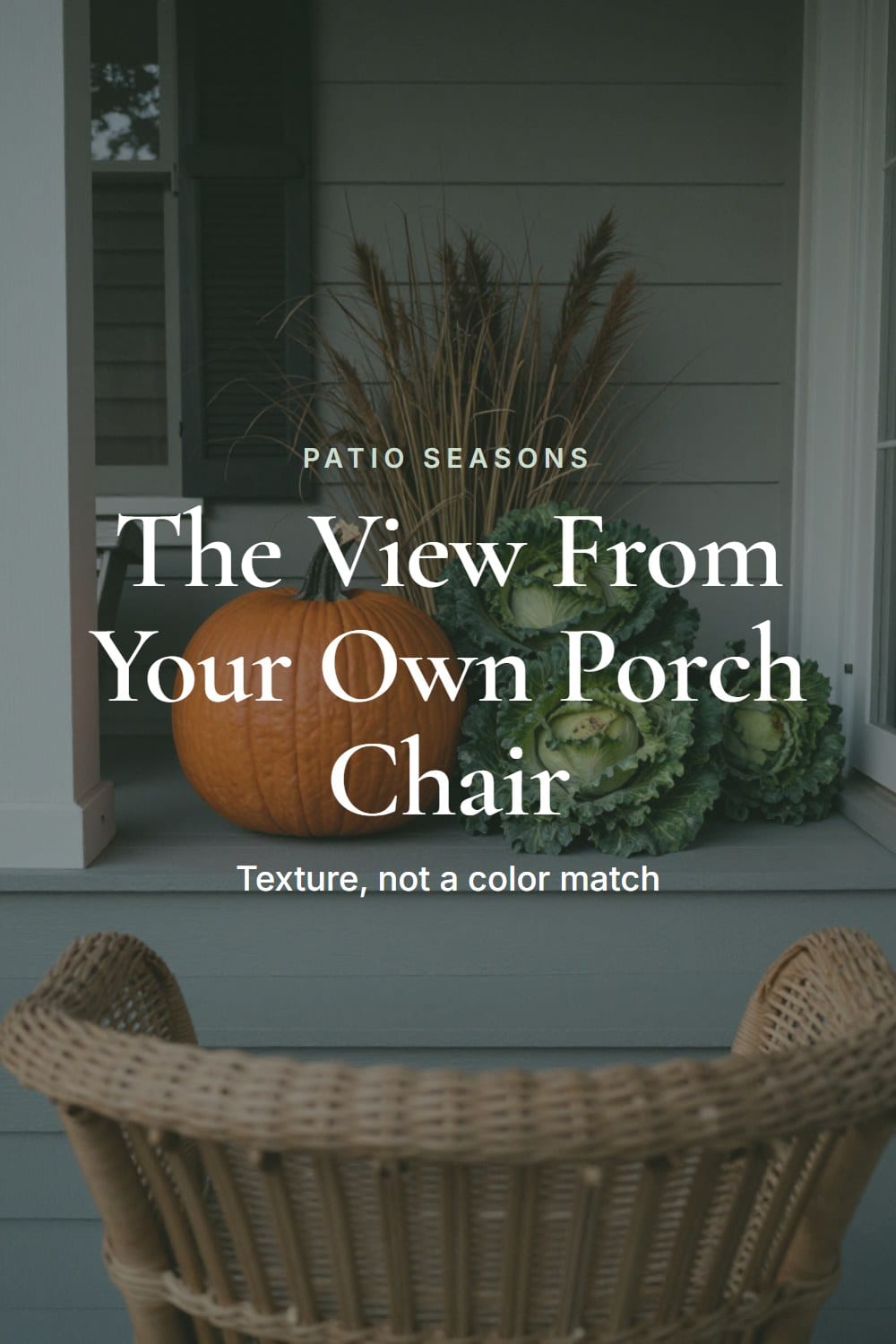 Seat-level view from a porch chair across a grouped vignette of an heirloom pumpkin, ornamental cabbage and dried grasses
