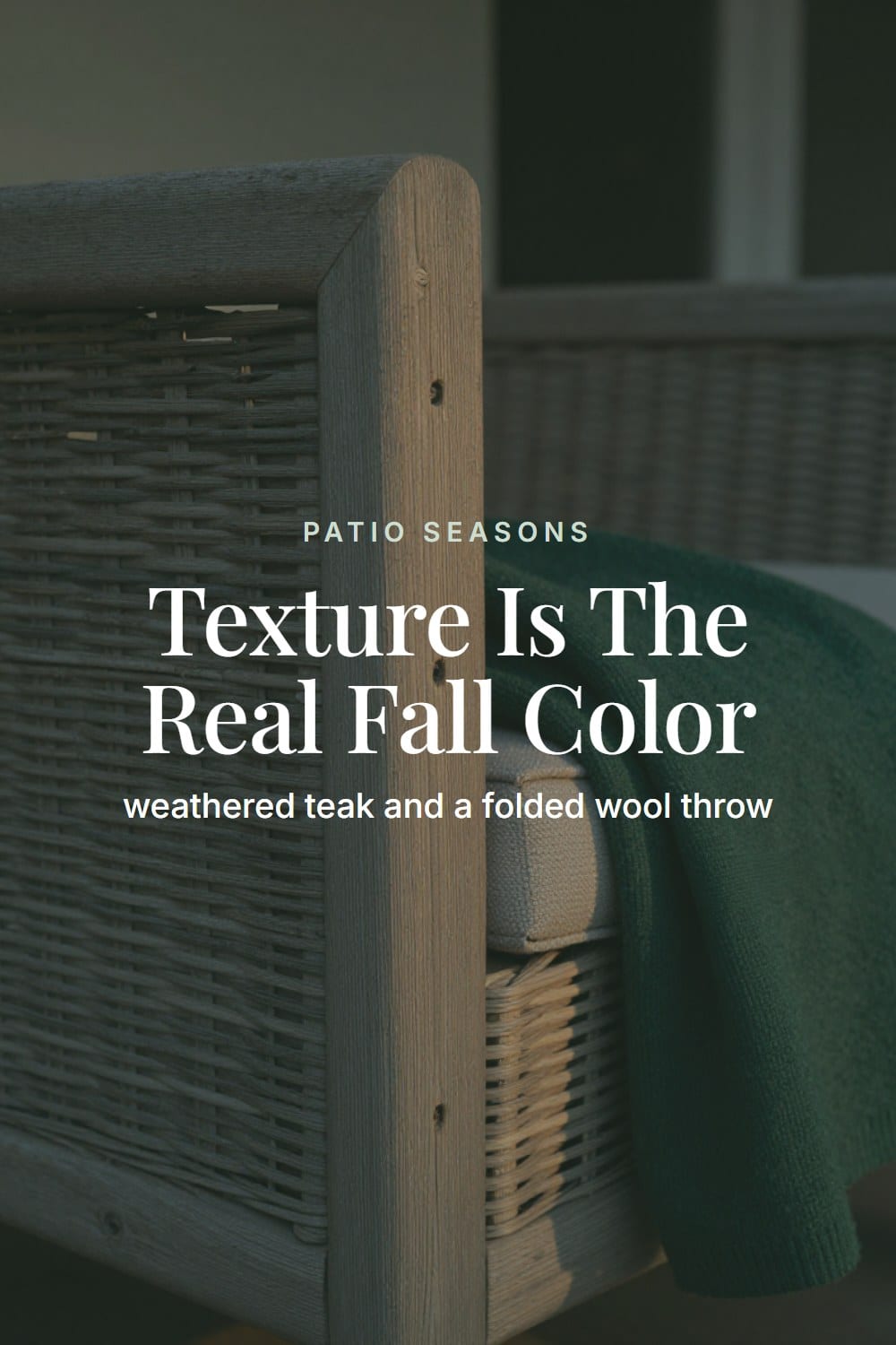 A low-angle close view of weathered teak grain and a folded wool throw on a fall porch