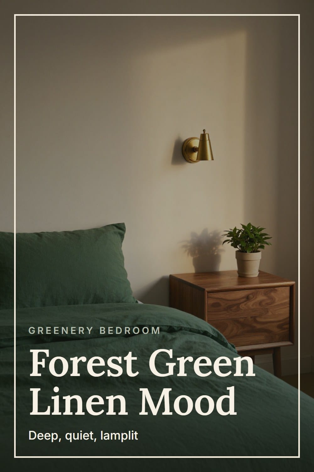 A bed in forest green linen bedding lit by an aged brass sconce beside a walnut nightstand