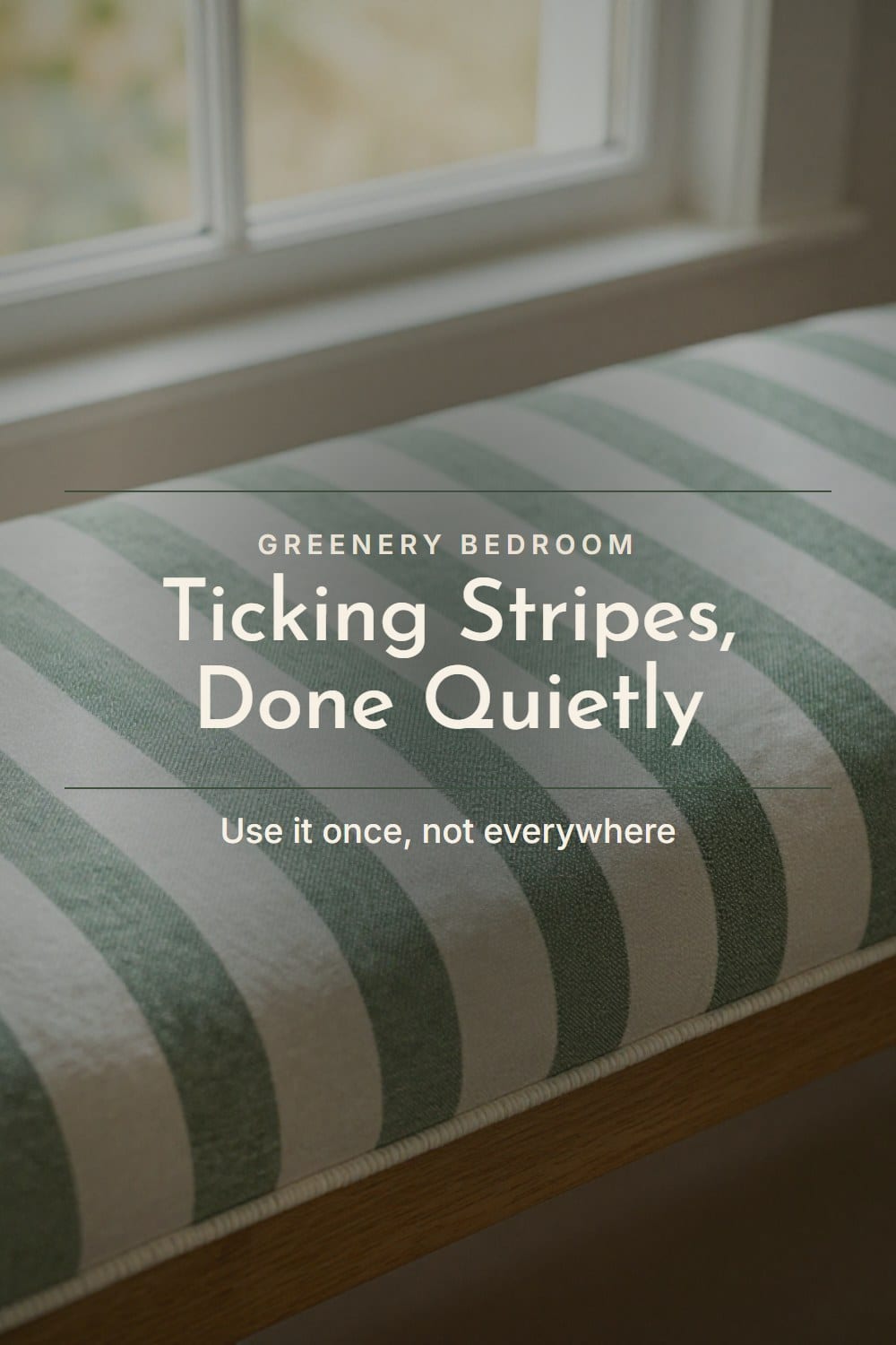 Green and white striped bedroom detail with narrow ticking stripes on a bench cushion with a corded edge at the foot of a bed