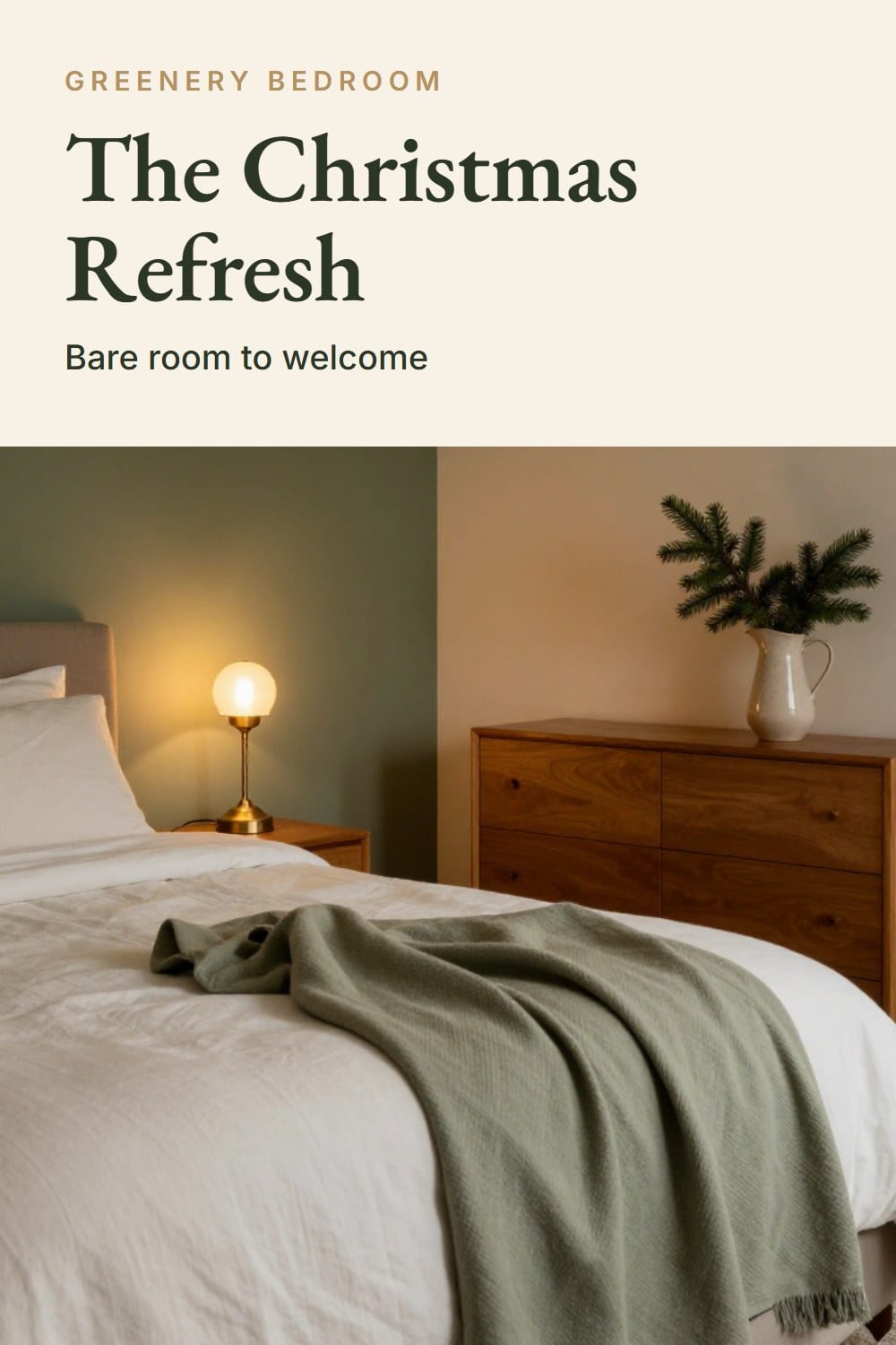 A freshly made guest bed by lamplight with a sage throw, a glowing brass lamp and a pitcher of fir on the dresser