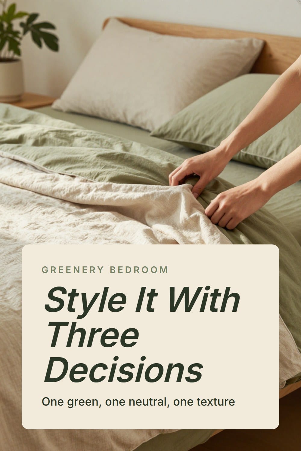 Hands smoothing a washed olive linen duvet across a slept-in bed with an oatmeal quilt folded at the foot