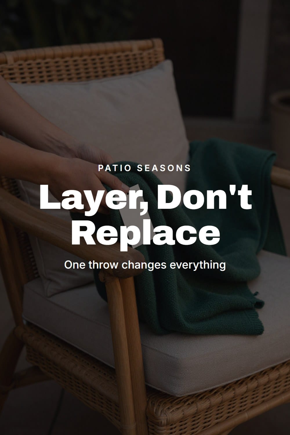 Hands folding a wool throw over a patio chair cushion