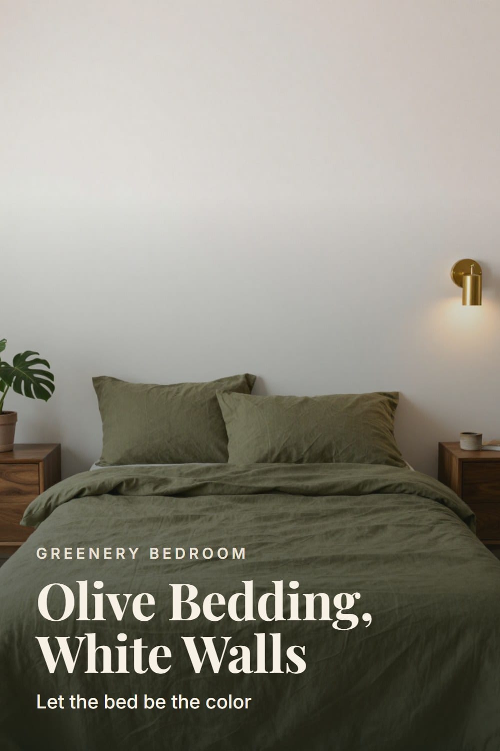 Straight-on view of an olive linen bed against a soft white plaster wall with walnut nightstands and a brass sconce