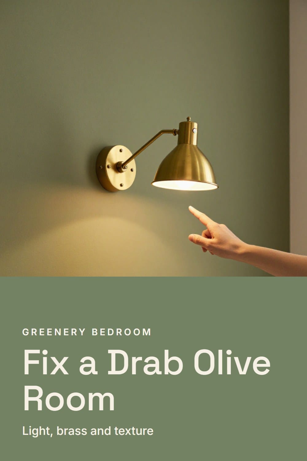 A hand switching on an aged brass swing-arm wall lamp beside an olive wall and an oatmeal boucle headboard at dusk