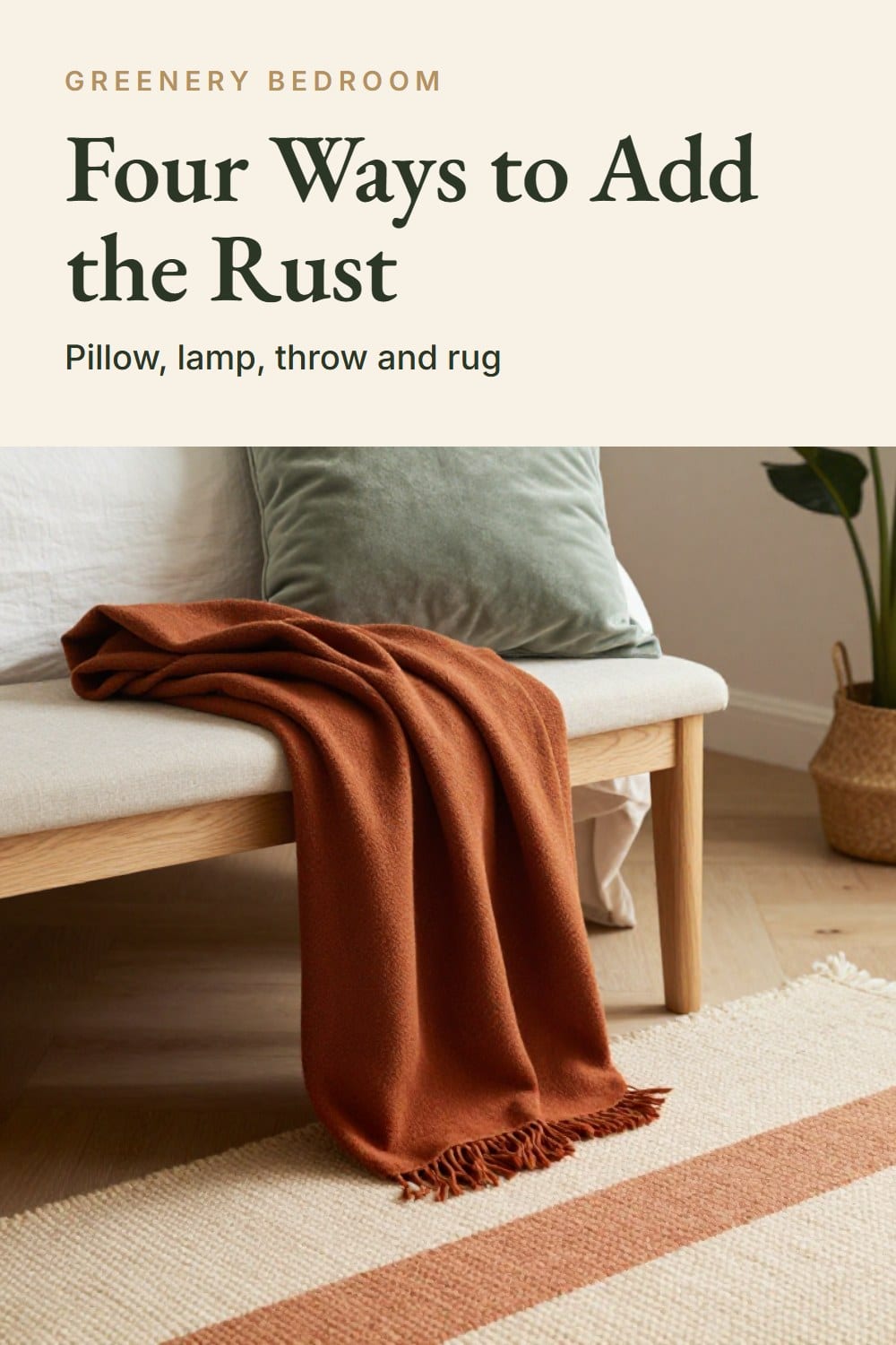 A bench at the foot of an oak bed holding a folded rust throw and a sage velvet cushion