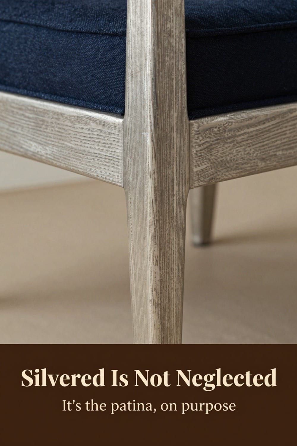 Low-angle close view of silvered teak grain on a chair leg in soft winter daylight