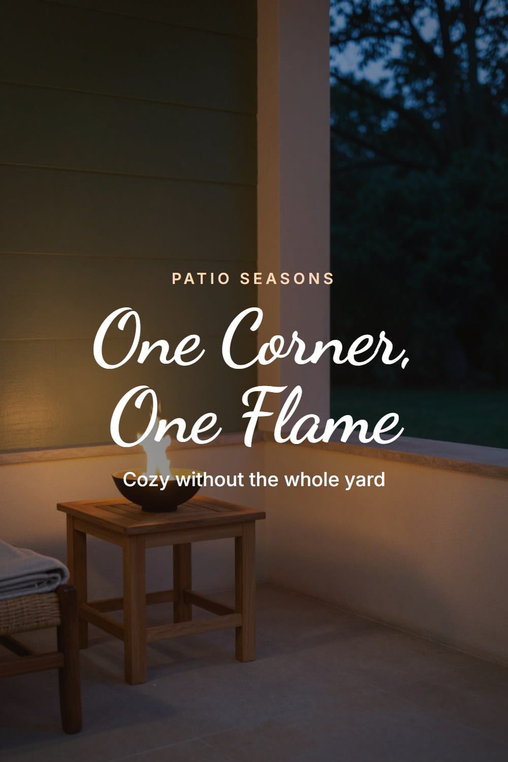 A quiet patio corner with a single small fire bowl lit beside a teak side table