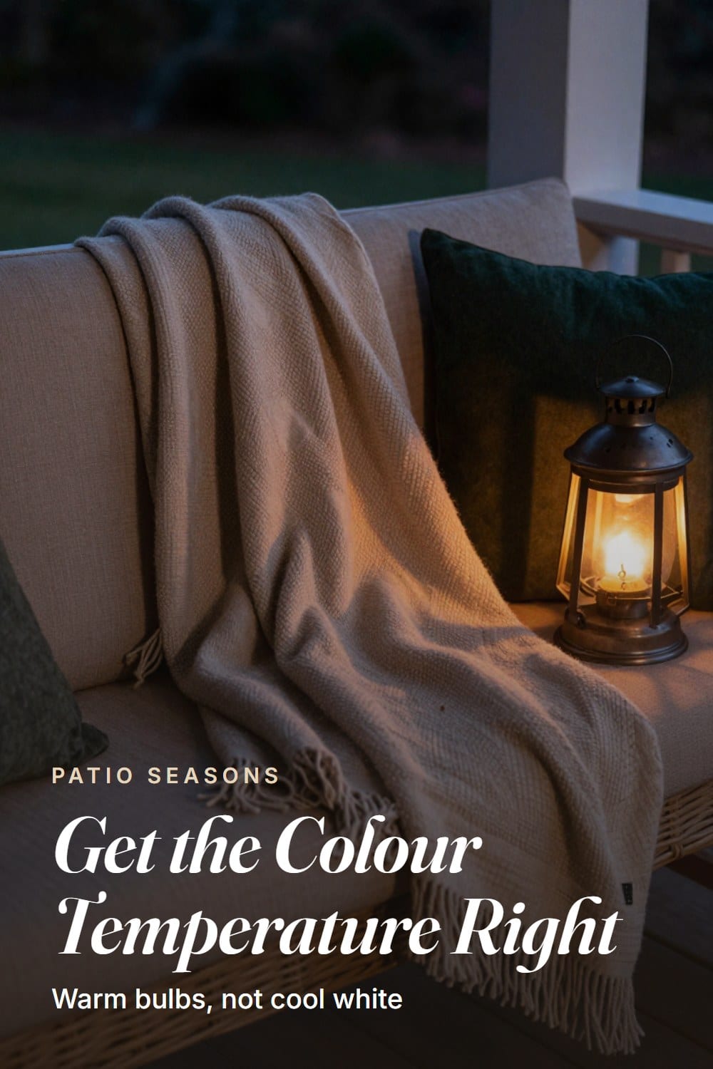 Close crop of layered fall textiles and a warm lantern glow on a porch bench